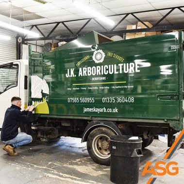 Acres Signs and Graphics team finish off the livery on a trailer