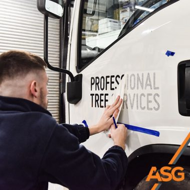 Acres Signs and Graphics team finish off the livery on a lorry